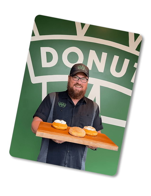 Manager holding a few delicous donuts